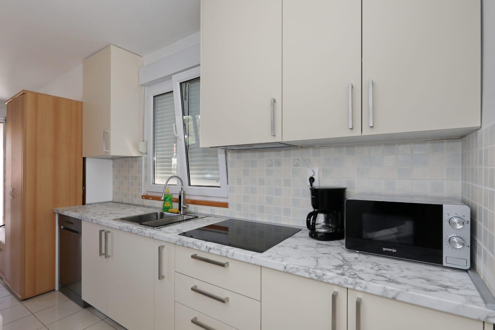 Apartman Gumbek — kuhinja s indukcijskom pločom, perilicom posuđa i mikrovalnom